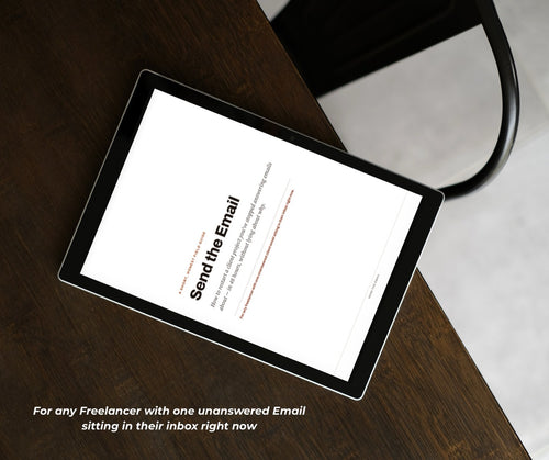 A tablet resting on a wooden desk, displaying the cover of the Send the Email guide